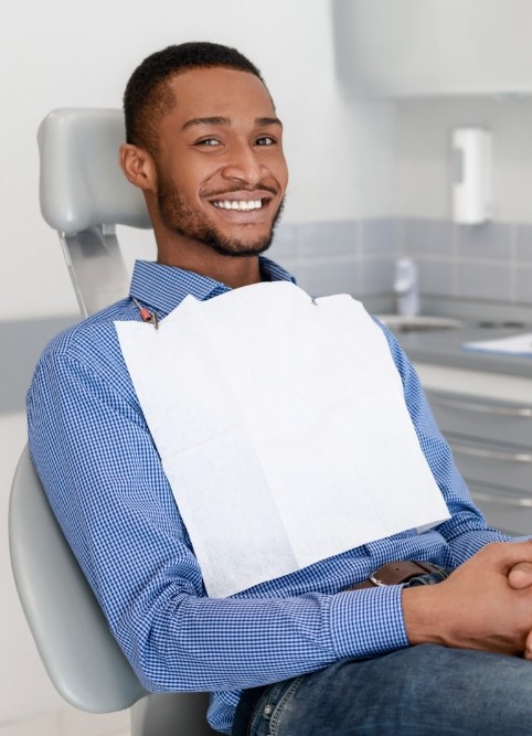 Smiling man sitting in dental chair