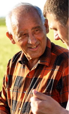 Senior man talking to other man outdoors