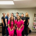 Smiling Texas Dental Excellence team members in scrubs