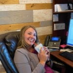 Dental team member sitting at desk with milkshake