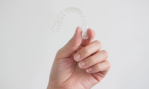 Patient holding clear aligner