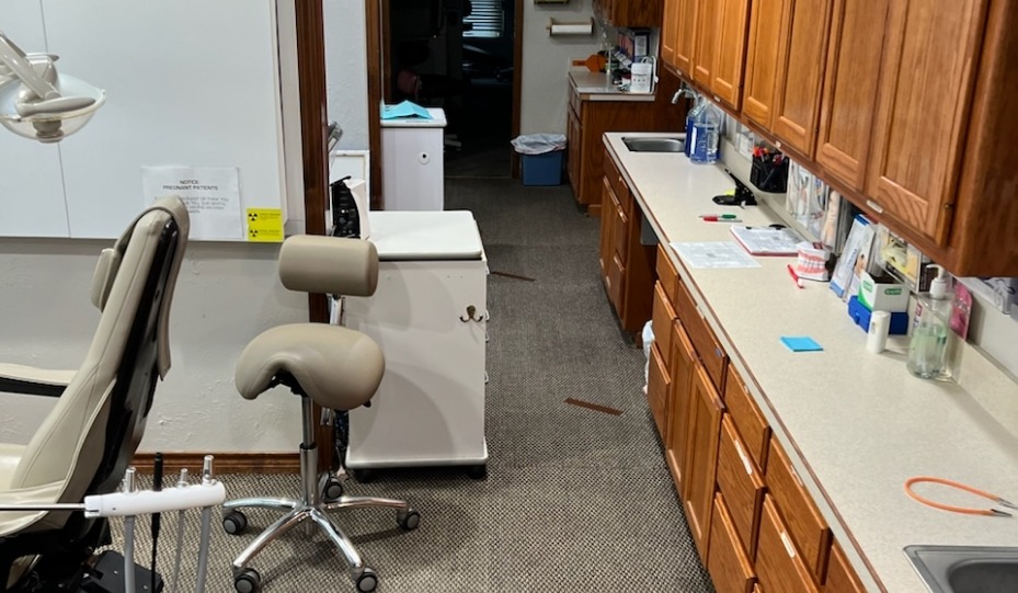 Countertop with sinks behind dental treatment chair