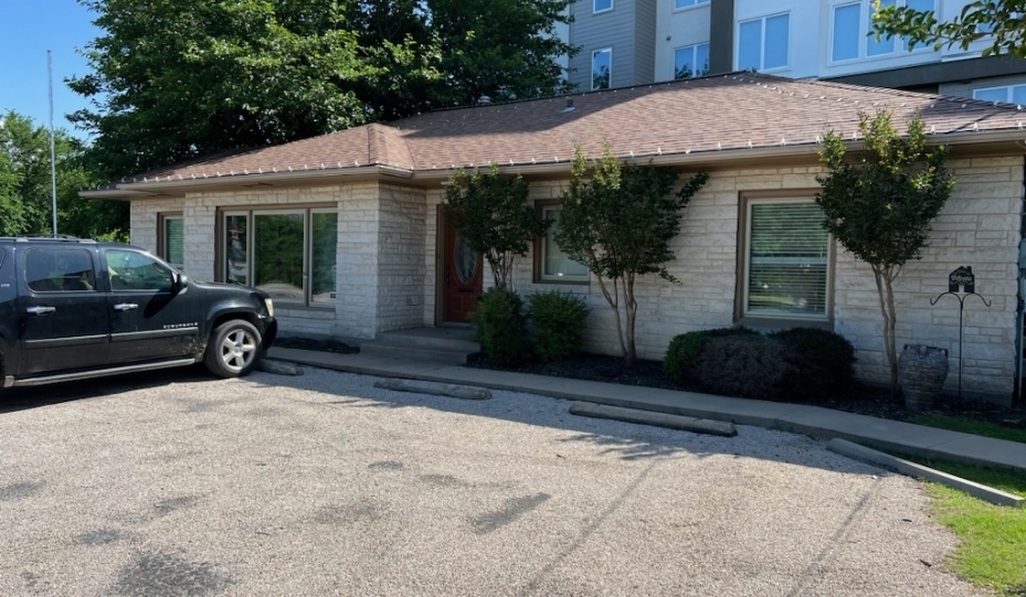 Black car parked outside of Stephenville dental office