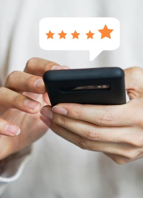 Person leaving a five star review on their phone