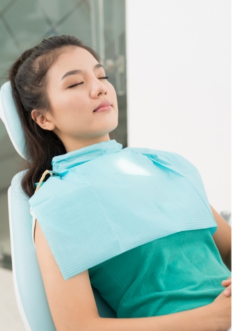 Woman relaxing in dental chair thanks to sedation dentistry in Stephenville and Eastland