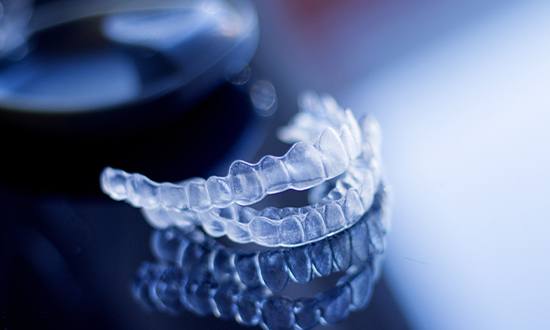 Two clear dental trays resting on a table